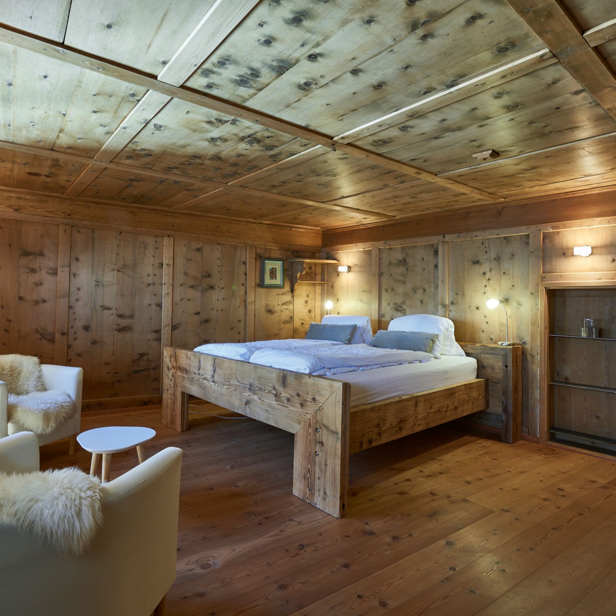 Im Schlafzimmer wurden die historischen Holzwände erhalten.